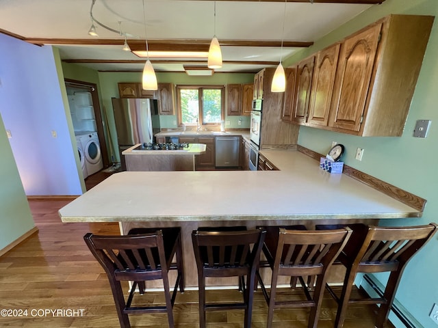 17041 Jacqueline Cir, Anchorage, AK 99516 - kitchen with appliances with stainless steel finishes, light countertops, a breakfast bar area, and a peninsula