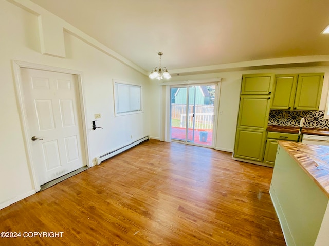 unfurnished dining area with vaulted ceiling, a notable chandelier, a baseboard heating unit, and light hardwood / wood-style floors