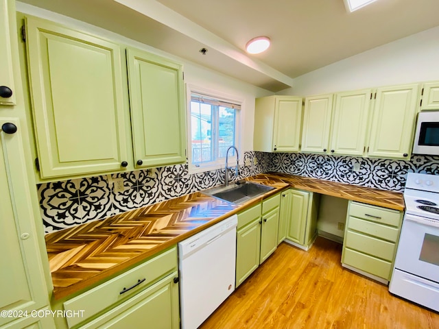 kitchen with white appliances, backsplash, sink, vaulted ceiling, and light hardwood / wood-style floors