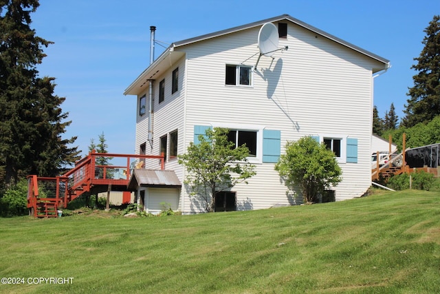 back of house with a yard and a wooden deck