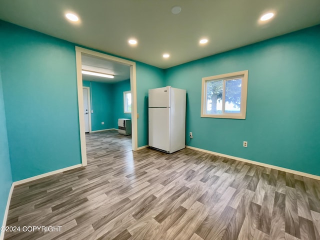 interior space with light hardwood / wood-style floors, white refrigerator, and a healthy amount of sunlight