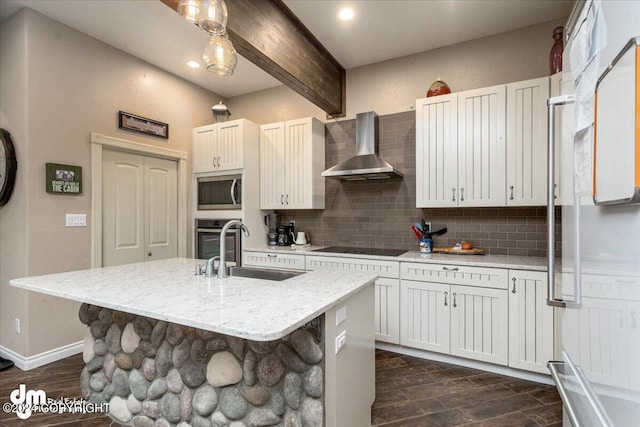 kitchen featuring sink, decorative backsplash, a kitchen island with sink, stainless steel appliances, and wall chimney exhaust hood