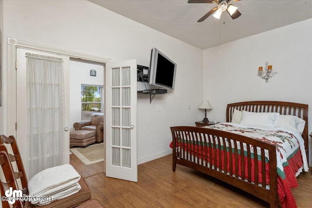 bedroom featuring french doors, ceiling fan, and hardwood / wood-style flooring