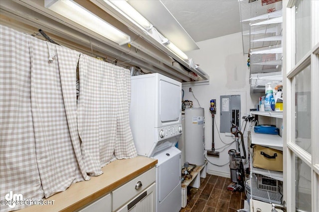 clothes washing area featuring stacked washer / dryer, gas water heater, and electric panel