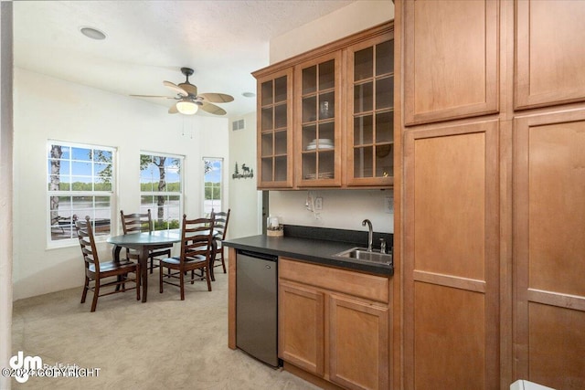 kitchen with dishwashing machine, sink, light colored carpet, and ceiling fan