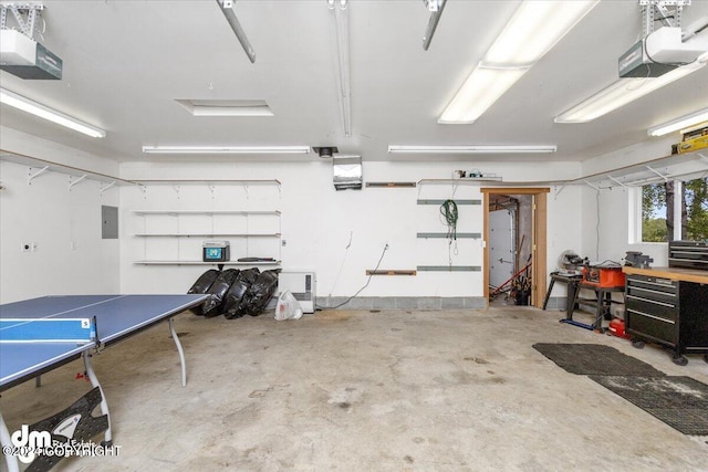 garage with a garage door opener and electric panel