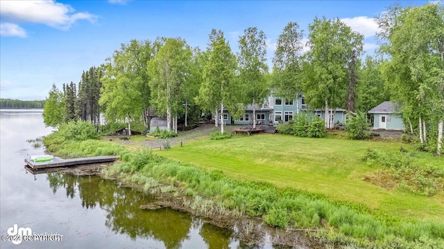 view of property's community featuring a water view and a yard