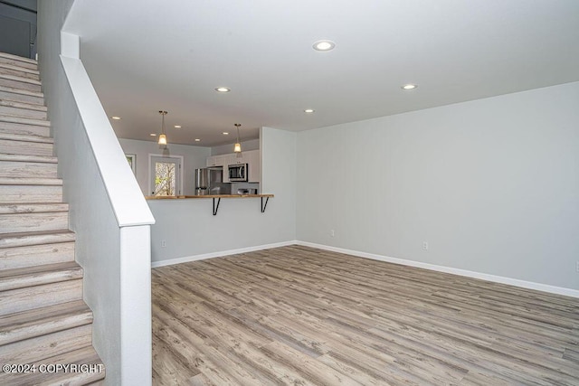 unfurnished living room featuring light wood-type flooring