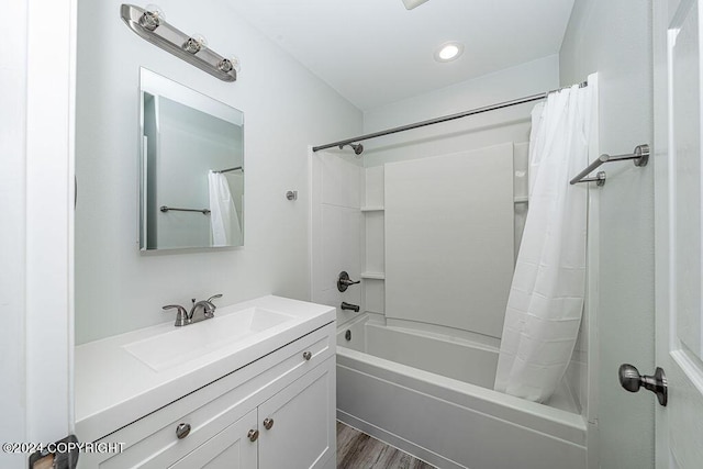 bathroom featuring shower / bath combination with curtain, wood-type flooring, and vanity