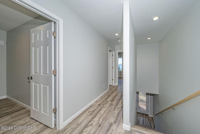 corridor with light hardwood / wood-style flooring