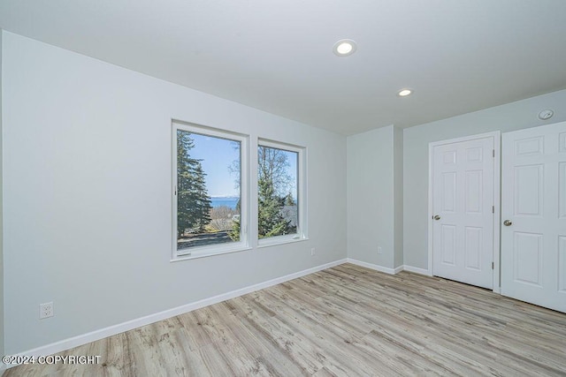 unfurnished bedroom with light wood-type flooring