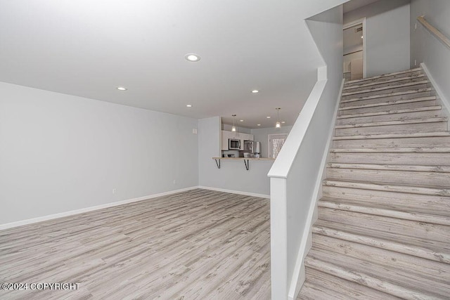 stairway with hardwood / wood-style floors