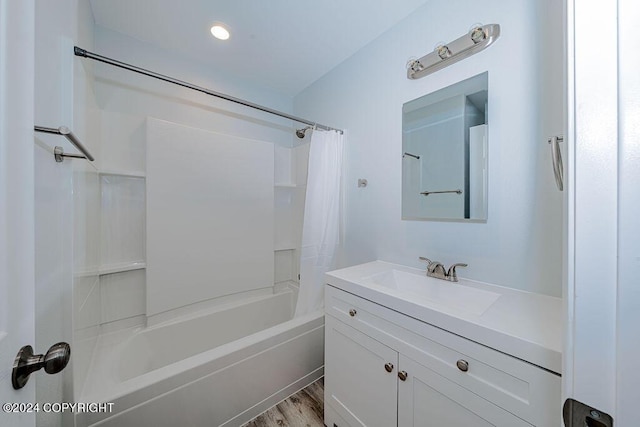 bathroom featuring shower / bathtub combination with curtain, hardwood / wood-style floors, and vanity