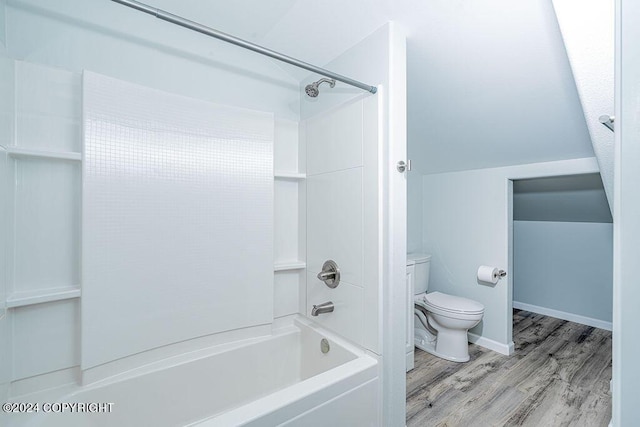 bathroom featuring toilet, hardwood / wood-style flooring, and tub / shower combination