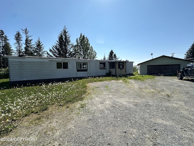 manufactured / mobile home featuring a garage and an outdoor structure