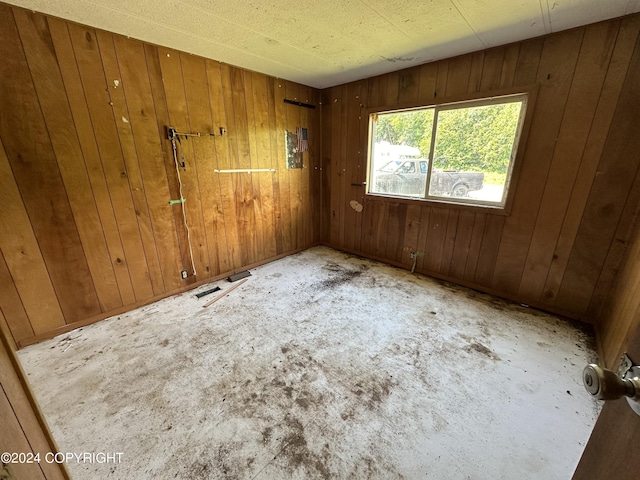 unfurnished room with wooden walls