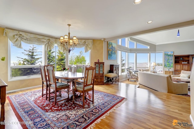 18706 Petrel Cir, Anchorage, AK 99516 - dining room featuring a chandelier, plenty of natural light, wood finished floors, lofted ceiling, and recessed lighting