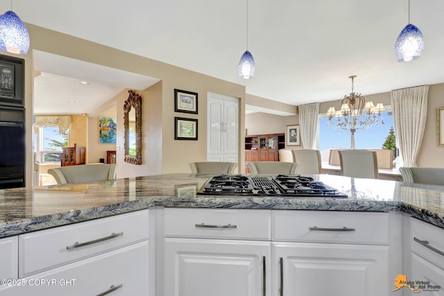 18706 Petrel Cir, Anchorage, AK 99516 - kitchen featuring black appliances, a chandelier, white cabinets, and light stone countertops