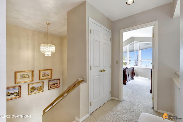 18706 Petrel Cir, Anchorage, AK 99516 - hall with an upstairs landing, light carpet, a chandelier, and baseboards