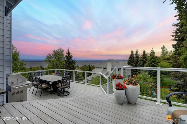 18706 Petrel Cir, Anchorage, AK 99516 - deck at dusk with outdoor dining area, area for grilling, and a water view