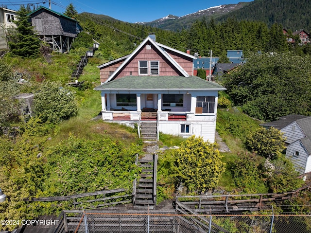 view of front of house with covered porch and a mountain view