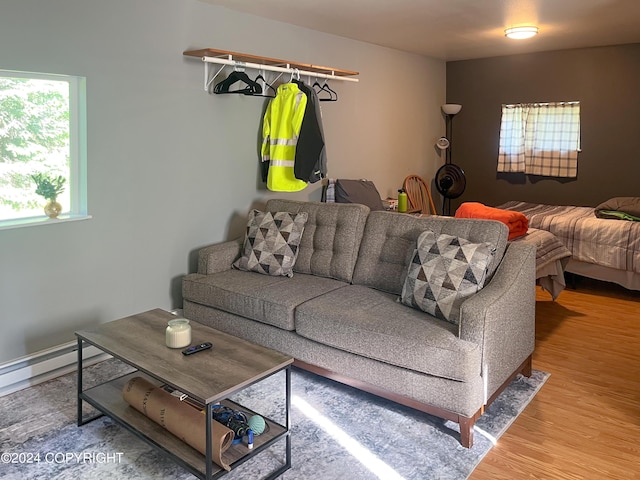 living room featuring hardwood / wood-style flooring and a baseboard heating unit