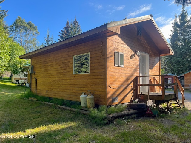 view of side of home with a yard