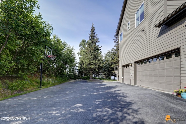 16268 Noble Point Dr, Anchorage, AK 99516 - view of property exterior with driveway and an attached garage