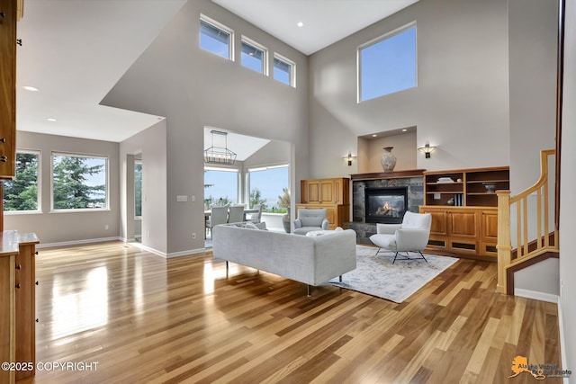 16268 Noble Point Dr, Anchorage, AK 99516 - living room with light wood finished floors, a premium fireplace, a towering ceiling, and recessed lighting