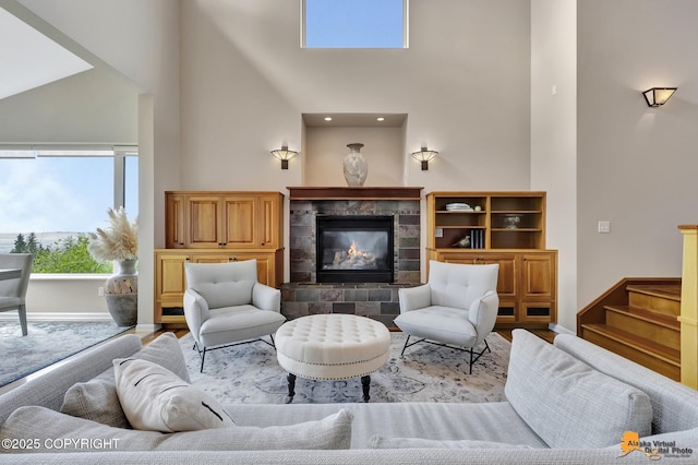 16268 Noble Point Dr, Anchorage, AK 99516 - living area featuring a towering ceiling, plenty of natural light, a tile fireplace, and wood finished floors