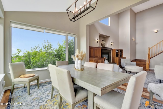 16268 Noble Point Dr, Anchorage, AK 99516 - dining area with high vaulted ceiling, wood finished floors, and stairs