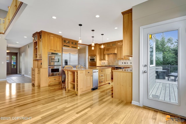 16268 Noble Point Dr, Anchorage, AK 99516 - kitchen with open shelves, appliances with stainless steel finishes, custom exhaust hood, a center island with sink, and light countertops