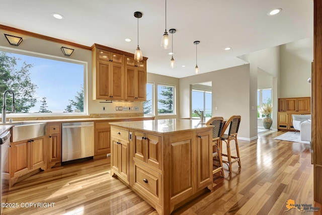 16268 Noble Point Dr, Anchorage, AK 99516 - kitchen with stainless steel dishwasher, a breakfast bar area, light wood-style floors, glass insert cabinets, and a center island