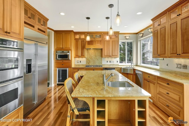 16268 Noble Point Dr, Anchorage, AK 99516 - kitchen featuring appliances with stainless steel finishes, light wood-style flooring, crown molding, brown cabinets, and wine cooler