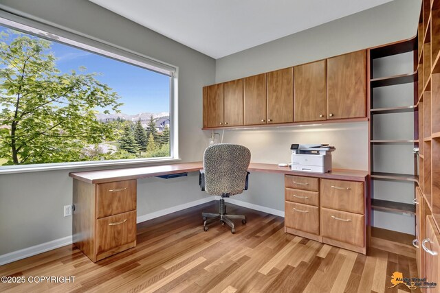16268 Noble Point Dr, Anchorage, AK 99516 - office area with built in study area and light wood-style floors