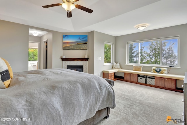 16268 Noble Point Dr, Anchorage, AK 99516 - bedroom with light carpet, a glass covered fireplace, and ceiling fan
