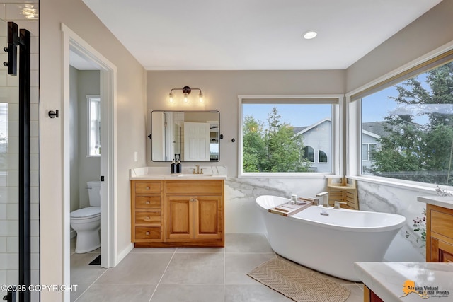 16268 Noble Point Dr, Anchorage, AK 99516 - full bathroom with vanity, a freestanding tub, healthy amount of natural light, and tile patterned floors