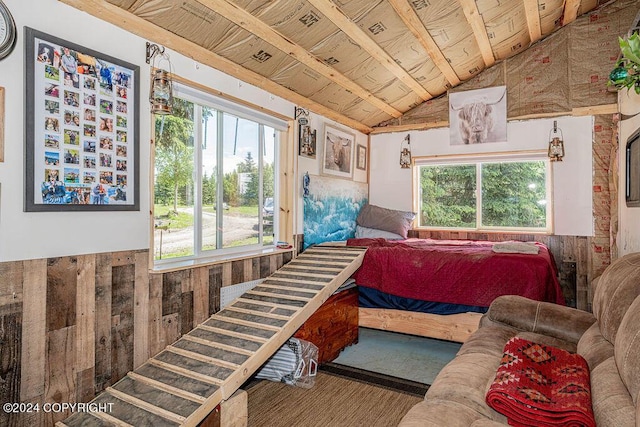 bedroom with wooden walls, wood ceiling, and lofted ceiling