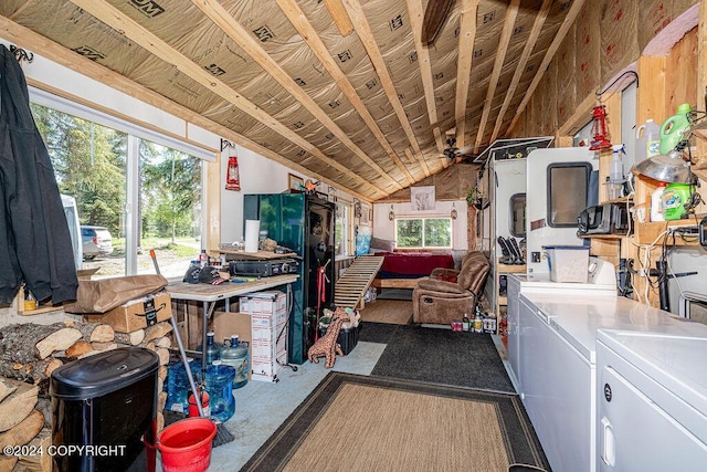 miscellaneous room featuring washer and clothes dryer and lofted ceiling