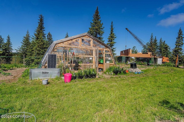 back of house featuring an outdoor structure