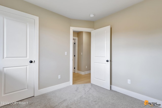 unfurnished bedroom featuring light colored carpet