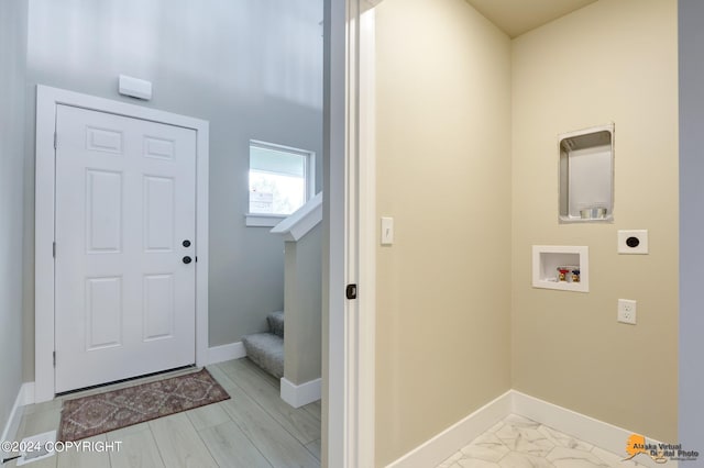 foyer entrance with light hardwood / wood-style floors