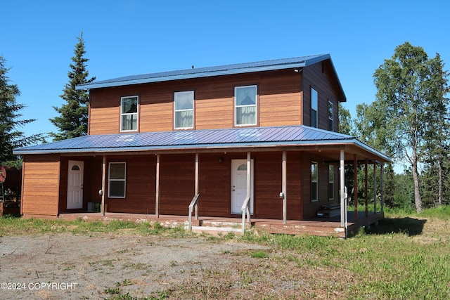 rear view of property featuring a porch