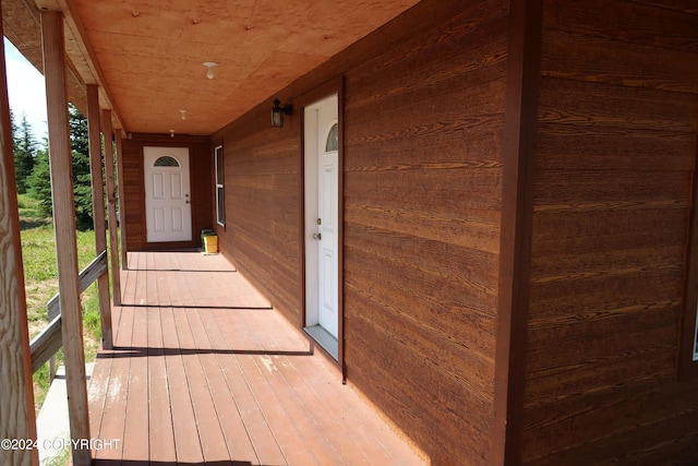 view of exterior entry featuring covered porch