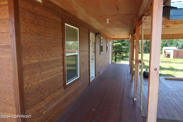 wooden terrace featuring covered porch