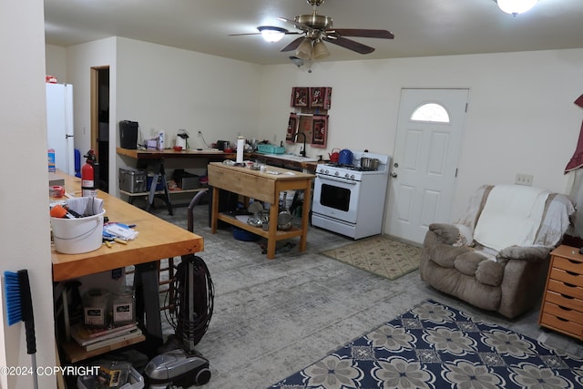 kitchen featuring ceiling fan, white appliances, and sink