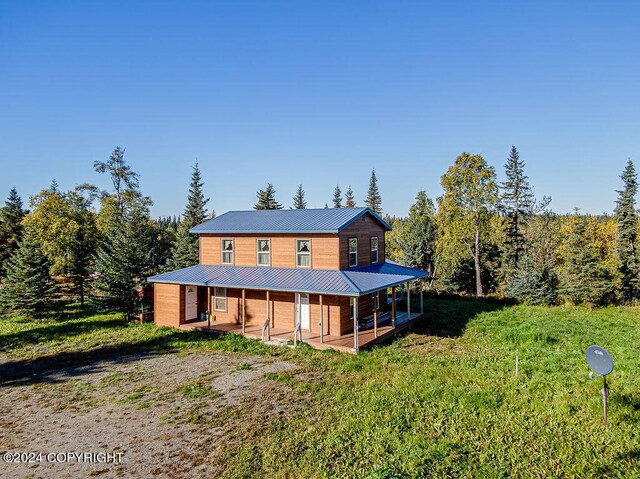 rear view of property featuring covered porch