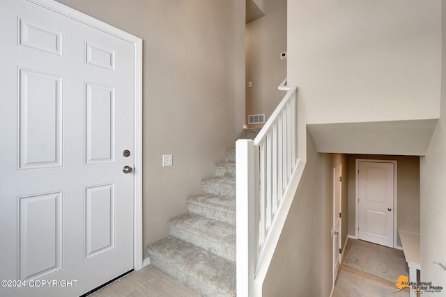 stairway with tile patterned floors