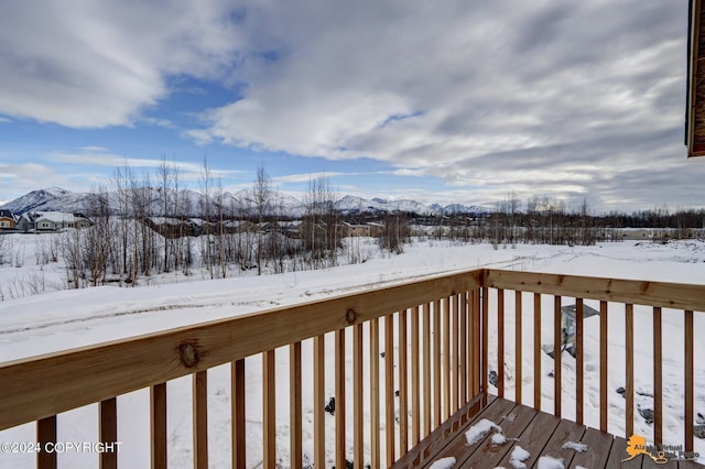 snow covered deck featuring a mountain view