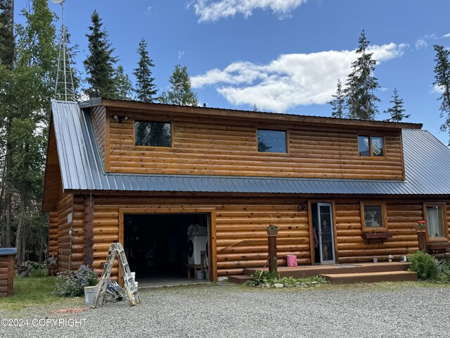 34335 Keystone Dr, Soldotna, AK 99669 - log home with driveway, a metal roof, and an attached garage